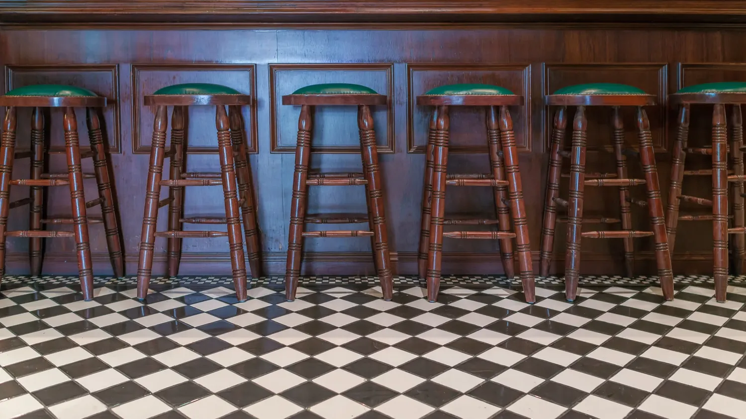 Empty bar stools in a British pub interior